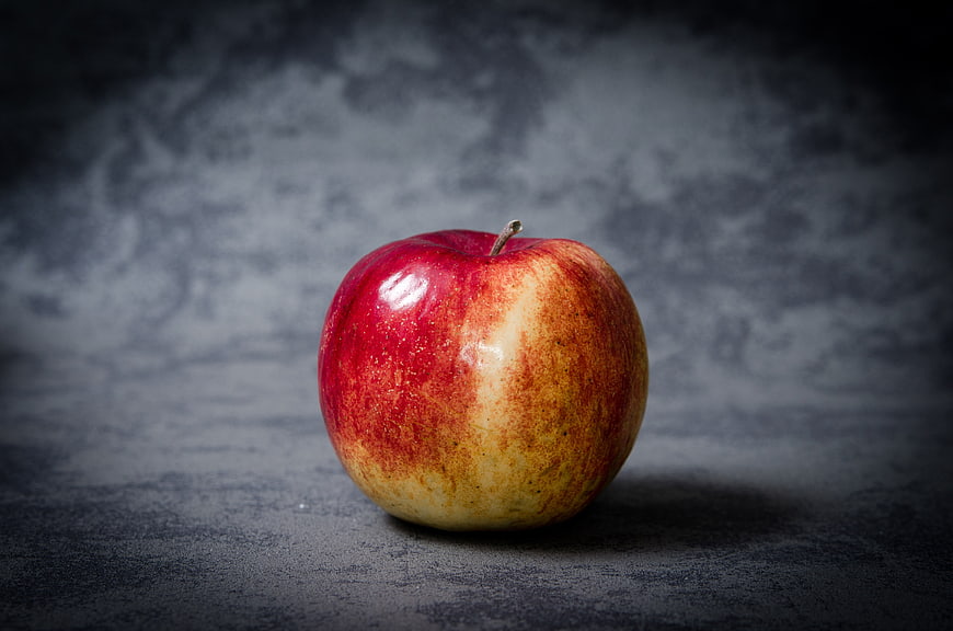 Red Apple on Dark Textured Background