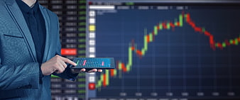 Businessman Using Calculator With Financial Stock Market Chart Background