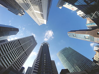 Low angle view of modern skyscrapers against blue sky