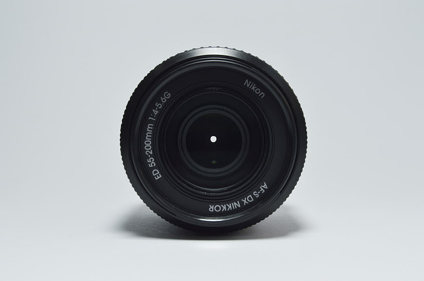 Black Nikon Camera Lens Isolated on White Background