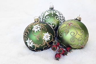 Green Christmas Ornaments in Snow with Red Berries