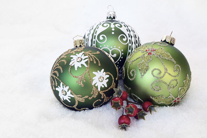 Green Christmas Ornaments in Snow with Red Berries