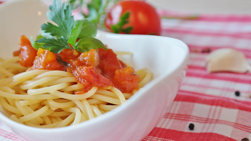 Spaghetti with Tomato Sauce and Fresh Parsley in White Bowl