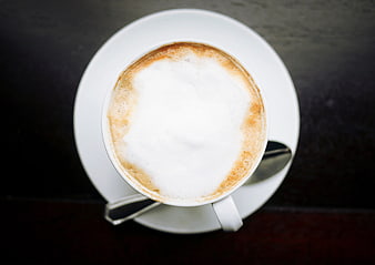 Top View of Cappuccino in White Cup on Dark Table