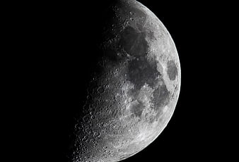 High-Resolution Crescent Moon with Craters Against Black Sky
