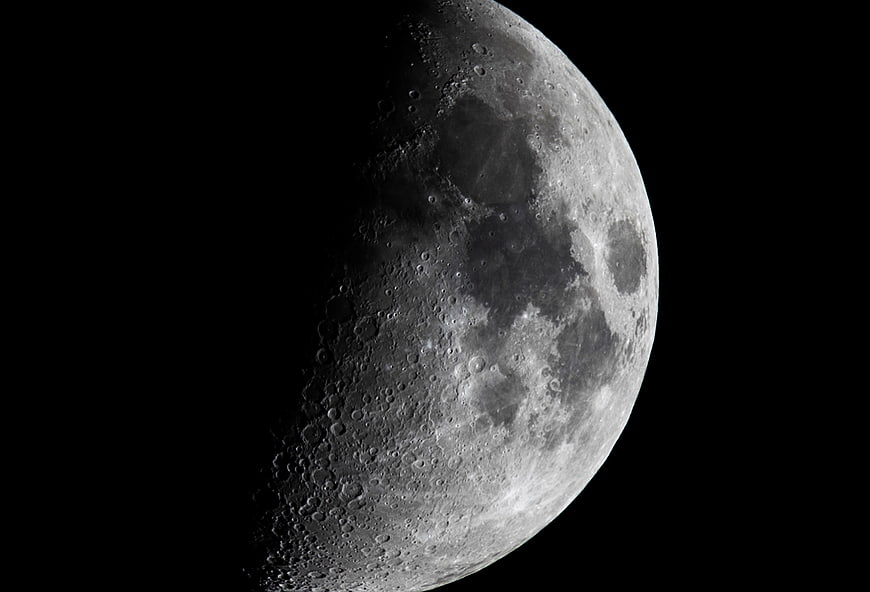 High-Resolution Crescent Moon with Craters Against Black Sky