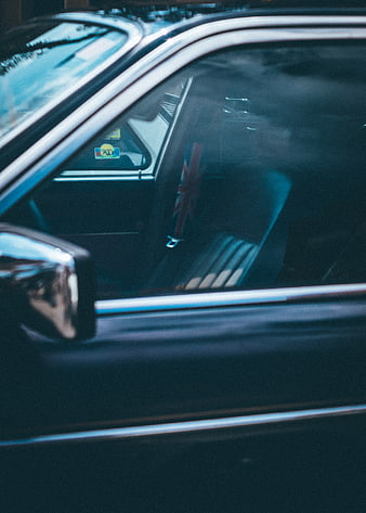 Close-up of vintage car window with Union Jack flag