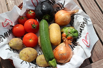 Fresh organic vegetables in a basket on wooden table