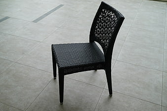Black Wicker Patio Chair on Tiled Floor