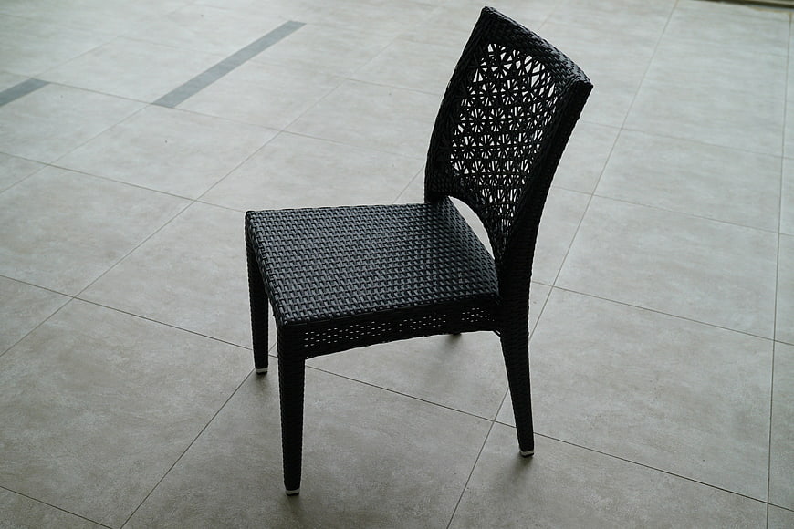 Black Wicker Patio Chair on Tiled Floor