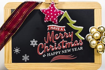 Merry Christmas and Happy New Year chalkboard greeting with festive decorations