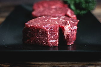Raw Beef Steaks on Black Slate Board