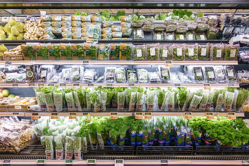 Organic vegetables and fresh greens in supermarket shelves