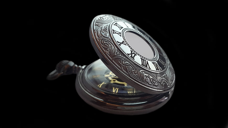 Vintage Silver Pocket Watch with Roman Numerals on Black Background
