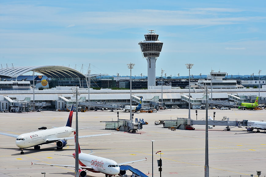 Wide view of Munich Airport tarmac with control tower and planes