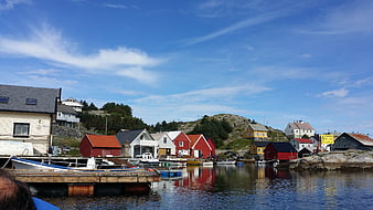Colorful Norwegian Fishing Village Harbor with Red Boathouses