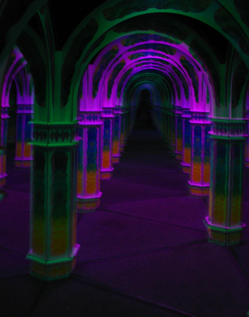 Neon lit arches in a dark tunnel