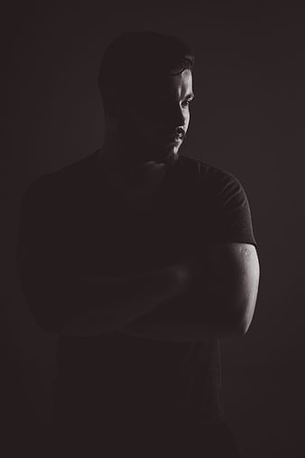 Dramatic Black and White Portrait of Man With Arms Crossed
