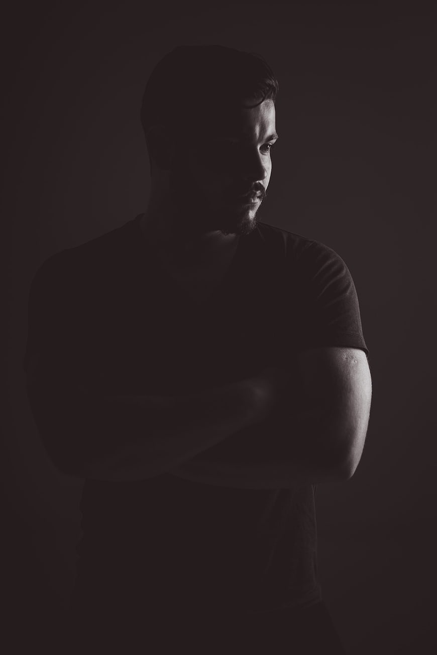 Dramatic Black and White Portrait of Man With Arms Crossed