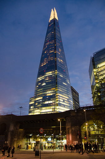 The Shard London skyscraper at dusk with city lights