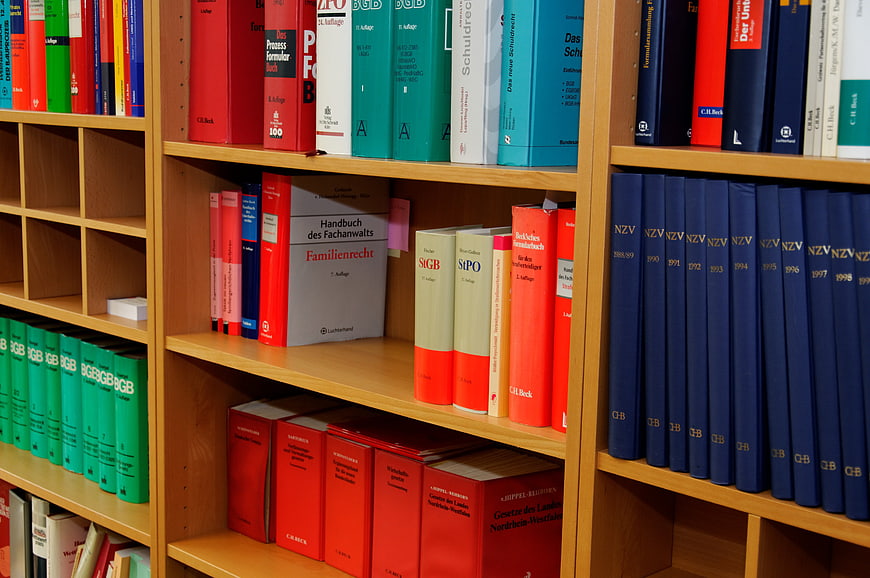 Colorful Law Books on Wooden Shelves in Library