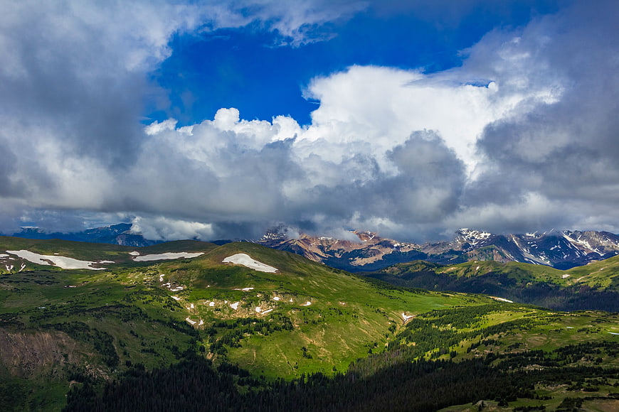 Majestic Mountain Landscape with Green Hills and Dramatic Clouds