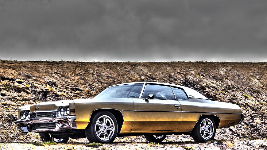 Gold Classic Chevrolet Impala on Grassy Hill