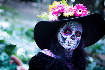 Woman with Day of the Dead Sugar Skull Makeup and Flower Hat