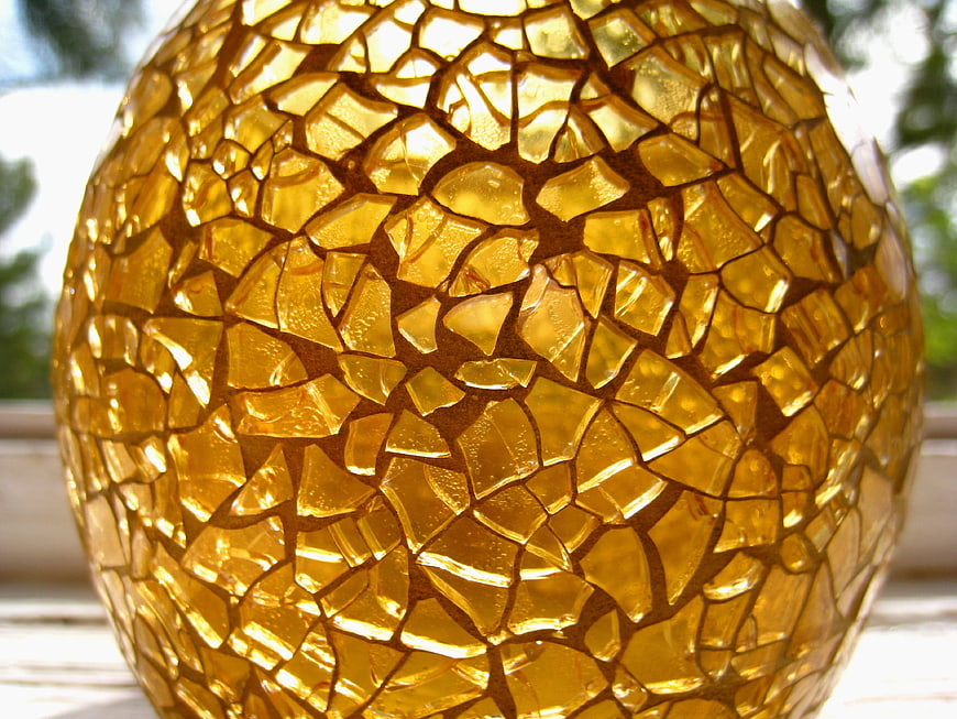 Close-up of golden mosaic glass candle holder
