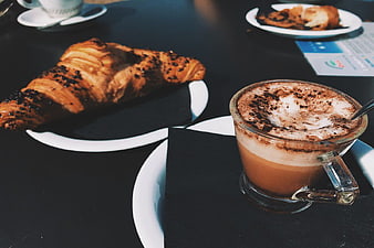 Cappuccino and Croissant on Black Table