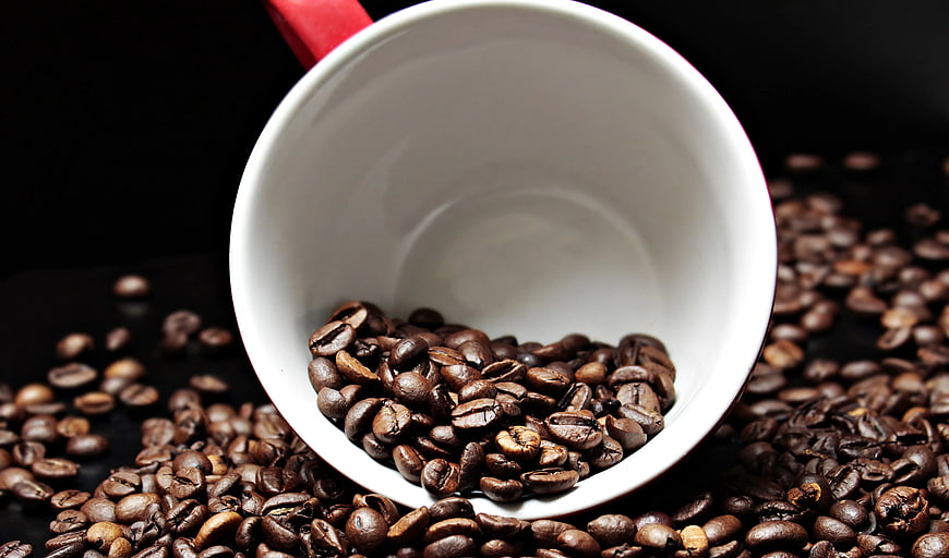 Roasted Coffee Beans in White Mug on Black Background