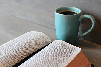 Open Bible and Blue Coffee Mug on Wooden Table