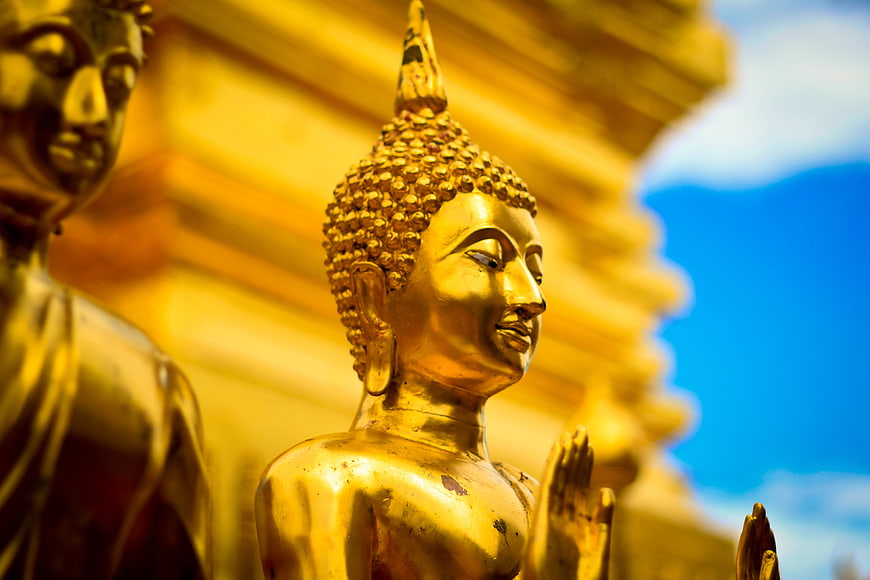 Golden Buddha Statue Close-Up Against Blue Sky