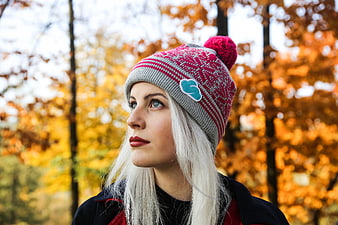 Woman in Pink Knit Beanie Looking Up in Autumn Forest