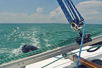 Sailing yacht rigging and turquoise ocean wake