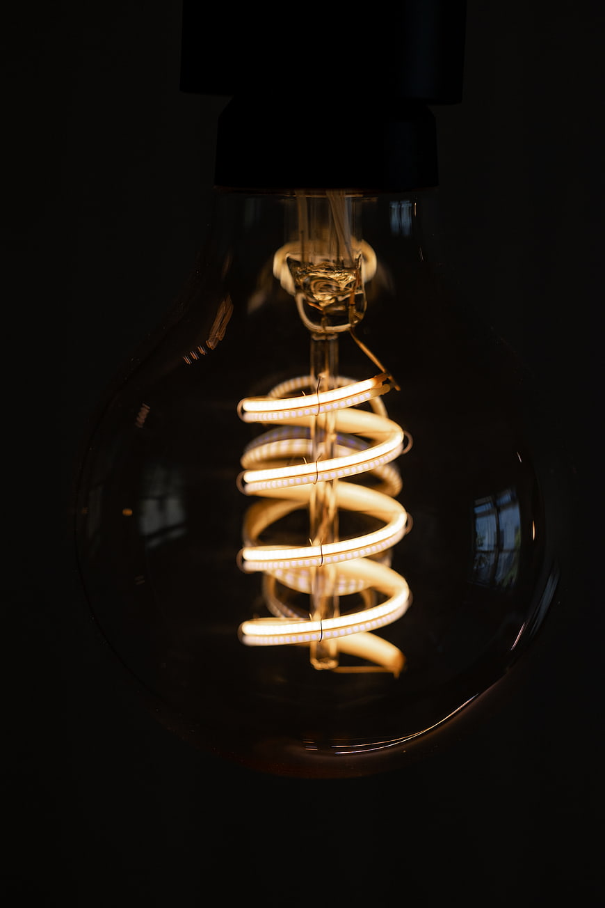 Illuminated Vintage Edison Light Bulb on Dark Background