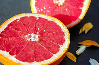 Fresh Pink Grapefruit Halves On Dark Slate Surface
