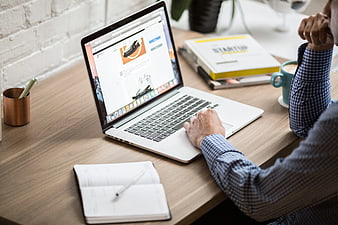 Businessman working on laptop at wooden desk