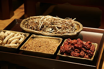 Traditional Chinese Medicine Herbs in Wooden Bowls