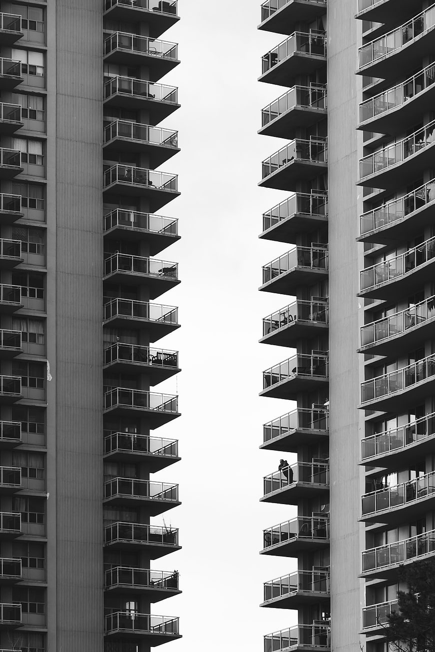 Black and white symmetrical view of modern apartment balconies