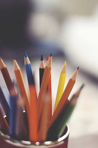Colored Pencils In A Metal Cup On A Blurred Desk