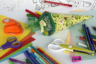 Colorful school supplies and party favor cone on craft paper