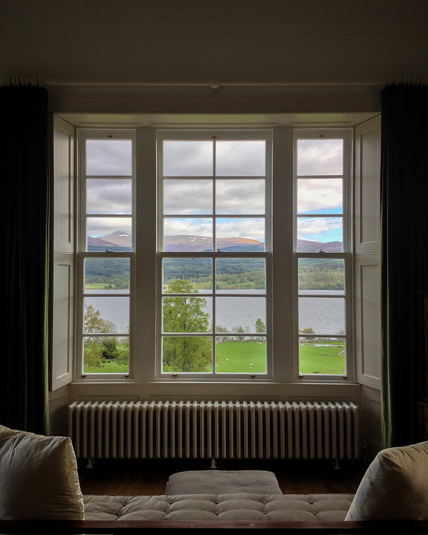 Interior View of Lake and Mountains Through Window