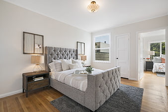Modern Gray Bedroom Interior with Tufted Bed and Hardwood Floors