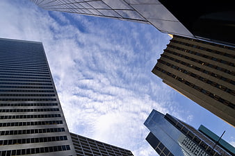 Low angle view of modern skyscrapers against blue sky
