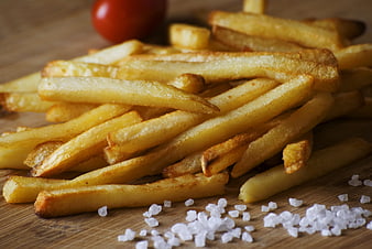 Golden French Fries with Sea Salt on Wooden Board