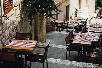 Outdoor restaurant terrace with red checkered tablecloths