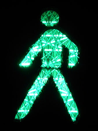 Green pedestrian traffic light signal at night