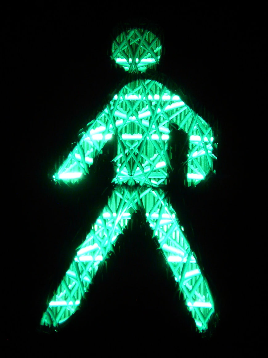 Green pedestrian traffic light signal at night