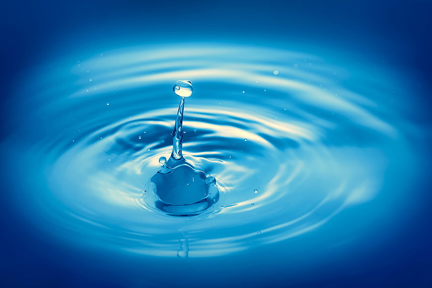 Blue water droplet splash with ripples on surface
